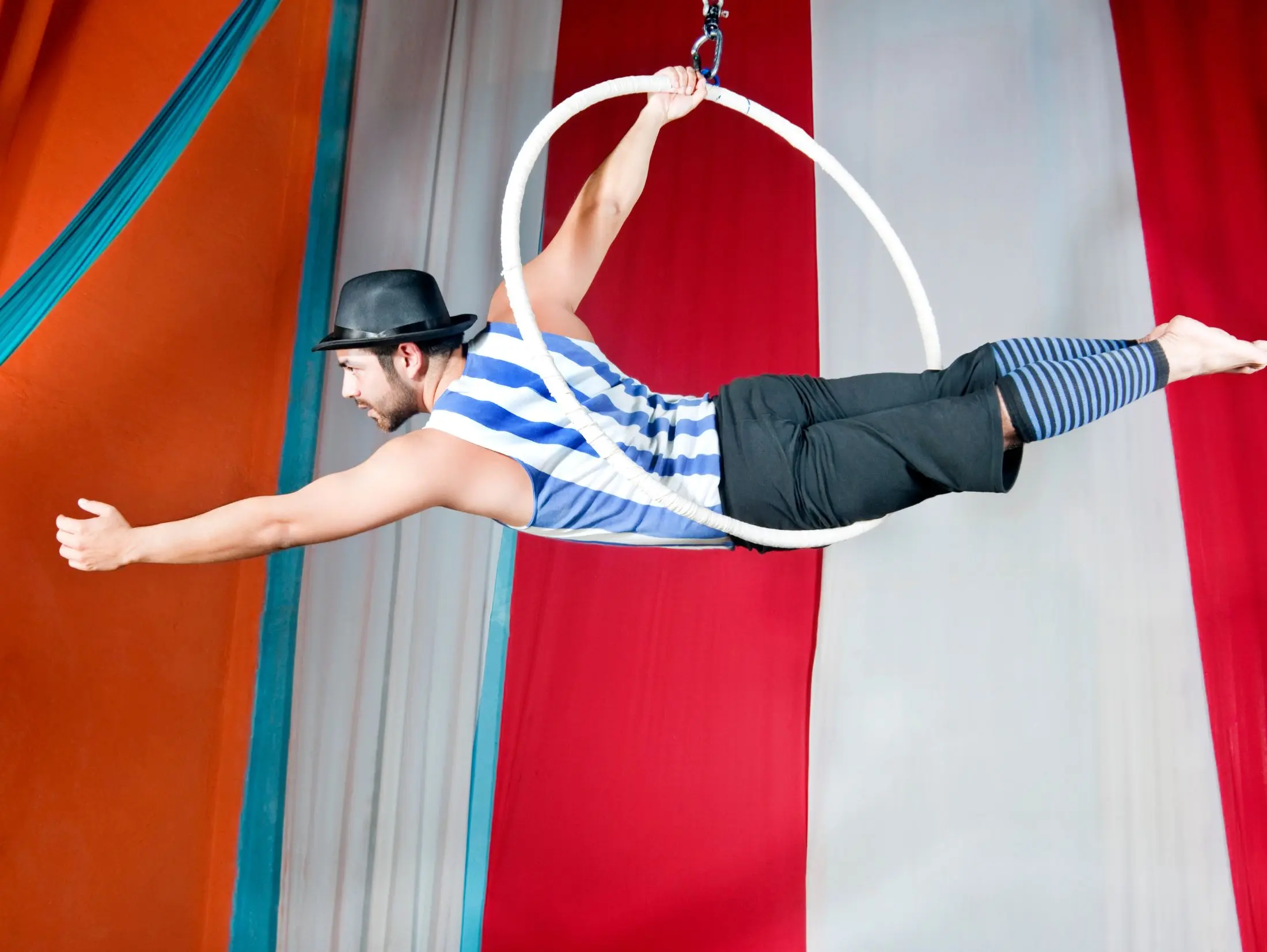 Circus fundraiser event with trapeze performer inside a big top tent